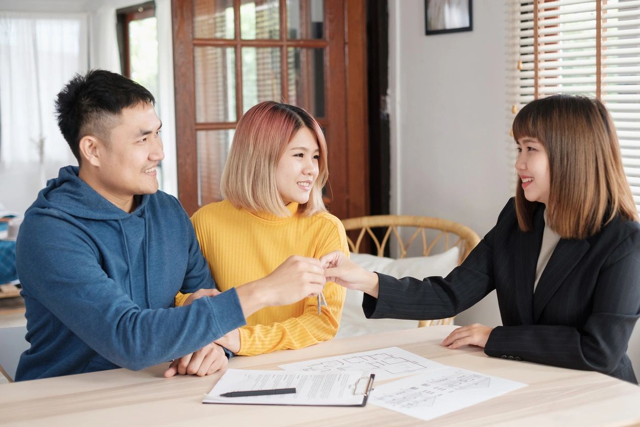 A woman is shaking hands with two people.