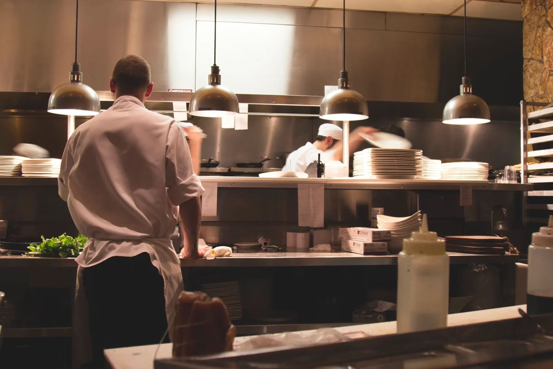 A man standing in front of some people cooking.