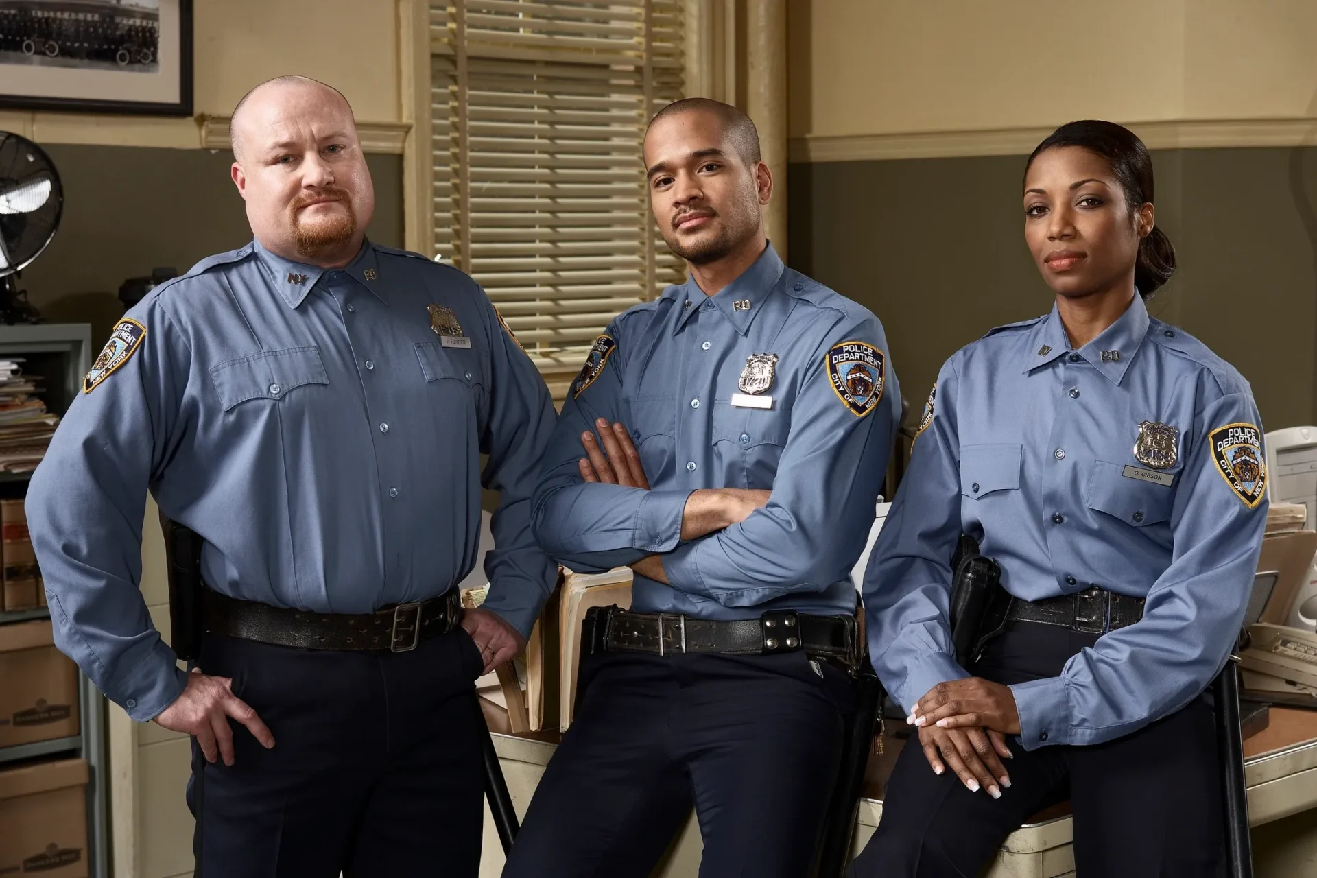 Three police officers posing for a picture.