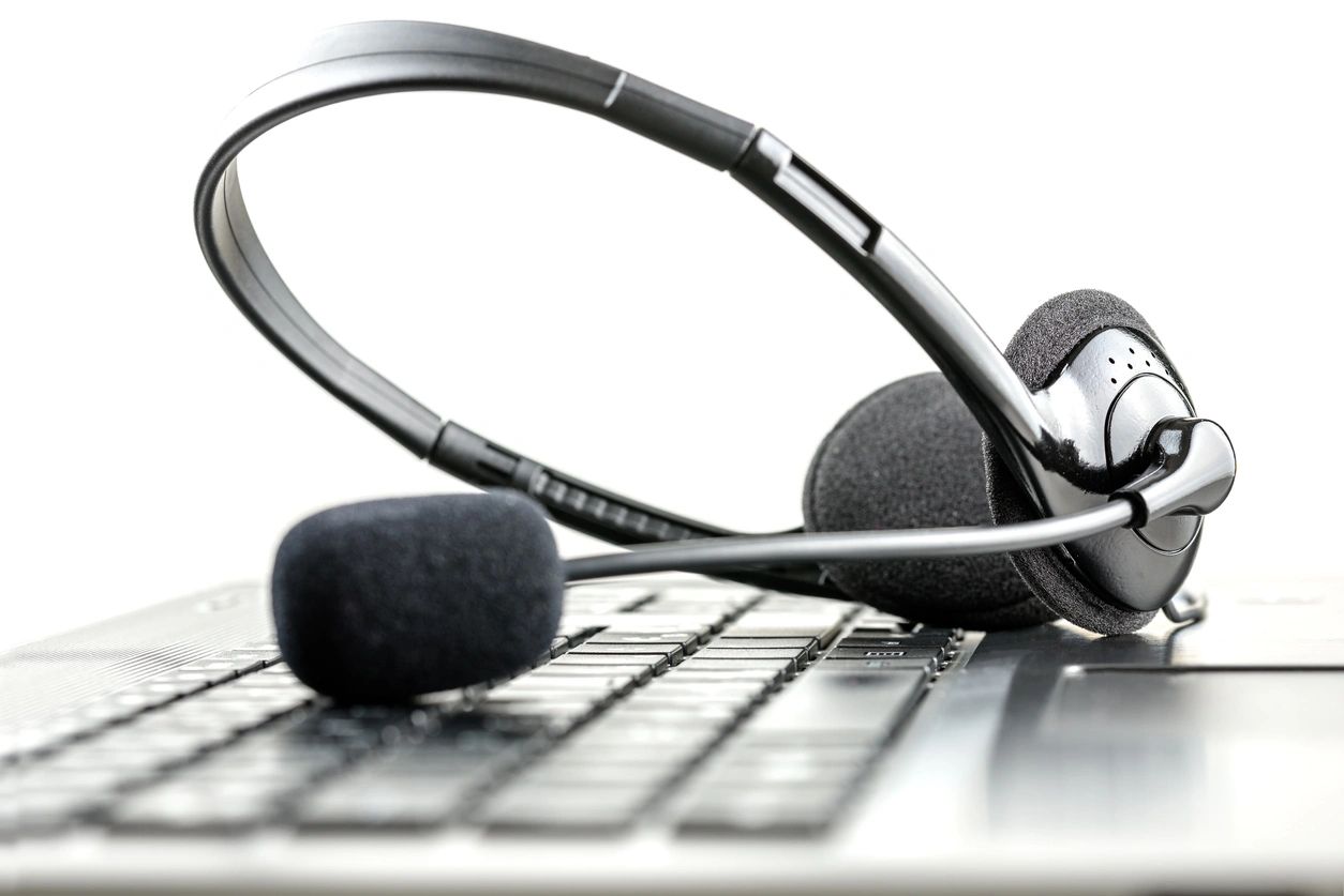 A pair of headphones sitting on top of a keyboard.